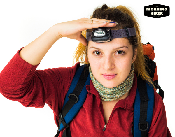 woman with a hiking headlamp on her head